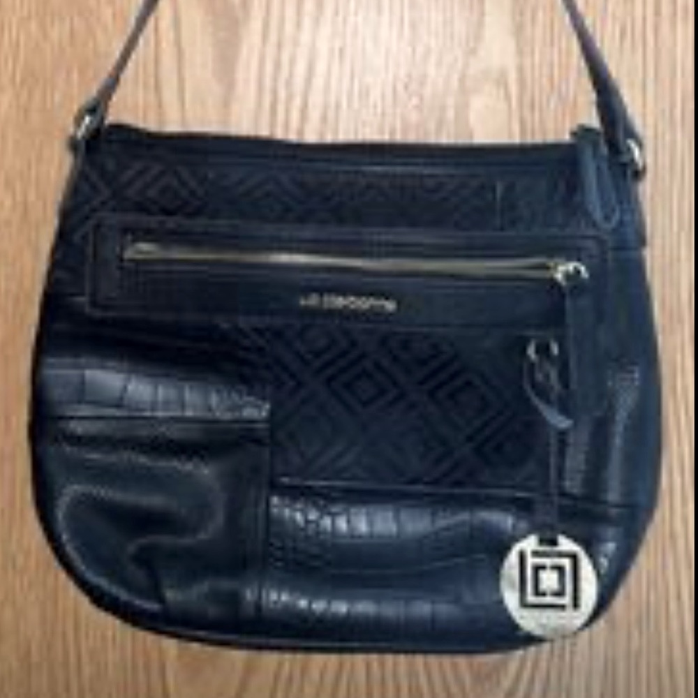 New Liz Claiborne Purse. Has several pockets medium size.